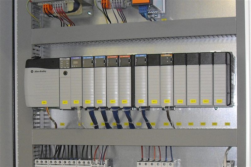 Industrial control panel showing the DIN-rail environment where safety controllers like the Pilz PNOZmulti 2 are installed alongside PLCs and I/O